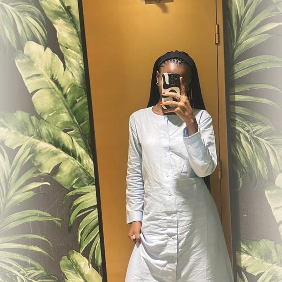 Model in powder blue kaftan with white wide-leg trousers
