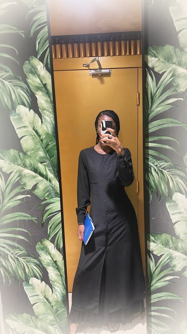 LJ look — long black button-front abaya with subtle tiered hem